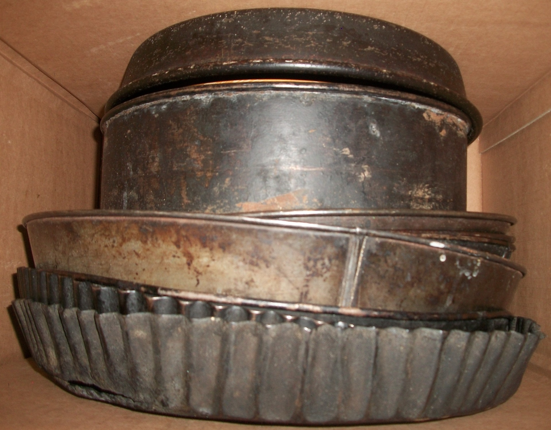 about a dozen 10"-15", 100-year-old baking pans; German
